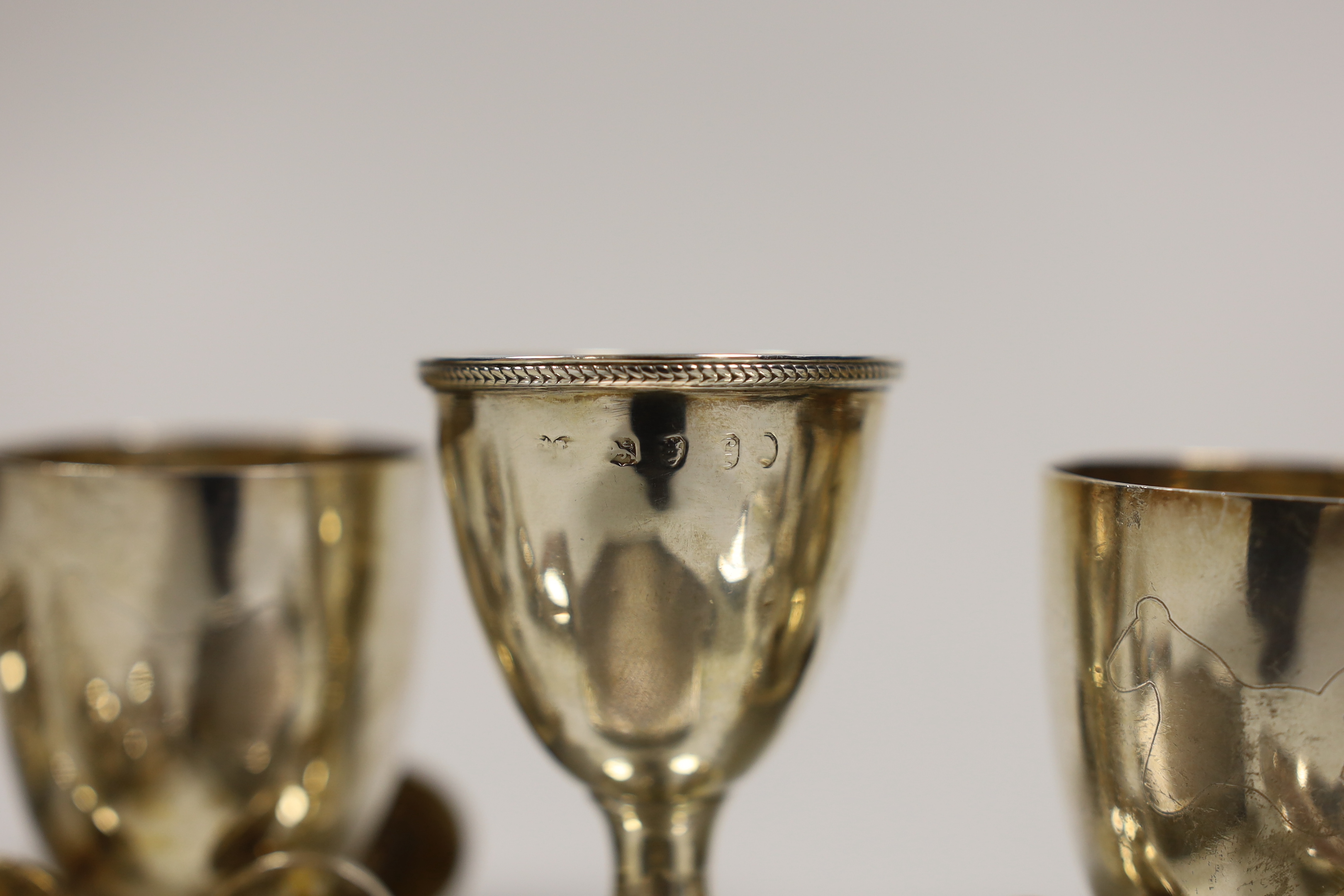 A George IV silver egg cup, London, 1821, 65mm, eight other small silver items including a pair of bun salts, 19th century caddy spoon, shell salt, compact, two pill boxes and a mounted glass scent bottle and two plated
